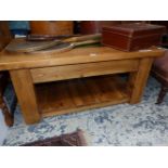 A 20th C. PINE TWO TIER COFFEE TABLE, THE TOP CENTRED BY A RECTANGLE OF GREEN GLASS. W 105 x D 76