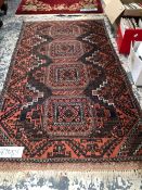 AN ANTIQUE BELOUCH RUG. 138 x 80cms