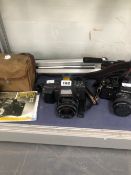 A YASHICA 230-AF CAMERA. A YASHICA FR1 CAMERA, A BOX CAMERA AND A TRIPOD