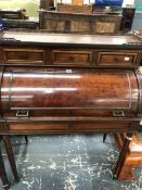 A 19th C. PLUM PUDDING MAHOGANY ROLL TOP BUREAU, THE BRASS GALLERIED TOP OVER THREE DRAWERS, THE