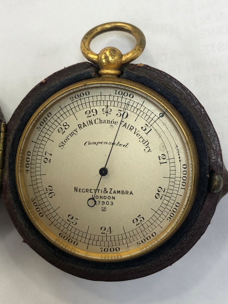 A NEGRETTI AND ZAMBRA POCKET BAROMETER IN LEATHER CASE.