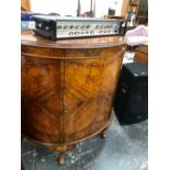 AN EARLY 20th C. WALNUT DEMILUNE CUPBOARD WITH THE DOOR ENCLOSING SHELVES. W 105 x D 50 x H 103cms.