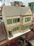 A MID 20th C. GABLE ENDED DOLLS HOUSE WITH FOUR ROOMS AND METAL WINDOWS