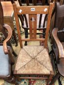 AN ARTS AND CRAFTS OAK SIDE CHAIR WITH HEART PIERCED SPLAT AND RUSH SEAT