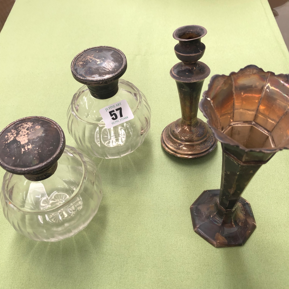 A PAIR OF SILVER MOUNTED GLASS LARGE SCENT BOTTLES, A SPILL VASE AND A CANDLE STICK.