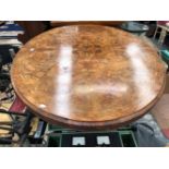 A VICTORIAN MARQUETRIED BURR WALNUT LOO TABLE, THE OVAL TOP ON FOUR COLUMNS AND LEGS WITH CARVED