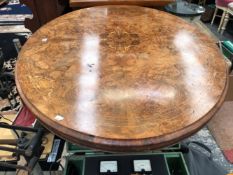 A VICTORIAN MARQUETRIED BURR WALNUT LOO TABLE, THE OVAL TOP ON FOUR COLUMNS AND LEGS WITH CARVED