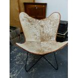 A 20th C.HIDE COVERED CHAIR SUPPORTED ON A TUBULAR IRON FRAME