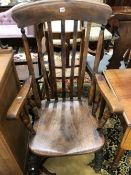 AN OAK SADDLE SEATED KITCHEN ELBOW CHAIR