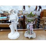 A ROYAL WORCESTER WHITE PORCELAIN LAMP BASE, TOGETHER WITH A GERMAN PORCELAIN FIGURAL BASKET ON