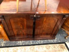 A PAIR OF VICTORIAN MAHOGANY BEDSIDE CUPBOARDS WITH SCROLL TOPPED PILASTERS FLANKING THE ROUND