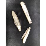TWO MOTHER OF PEARL AND SILVER FRUIT KNIVES AND A SIMILAR PICNIC FORK.