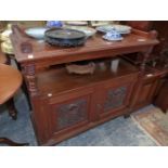 A VICTORIAN MAHOGANY BUFFET, THE THREE QUARTER GALLERIED TOP OVE AN OPEN SHELF, TWO CARVED