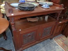 A VICTORIAN MAHOGANY BUFFET, THE THREE QUARTER GALLERIED TOP OVE AN OPEN SHELF, TWO CARVED