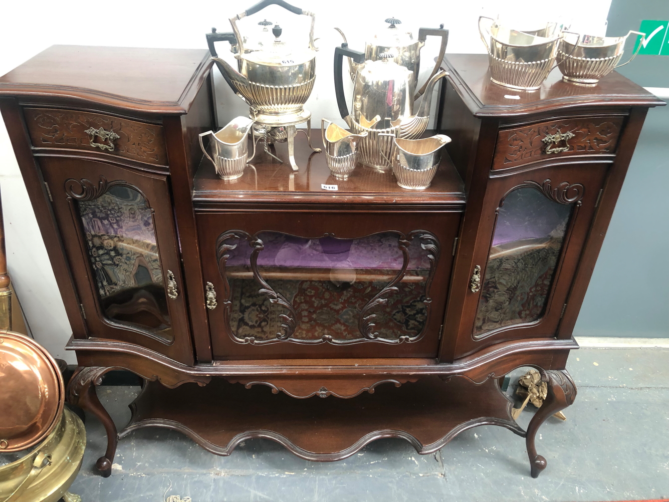 A LATE VICTORIAN MAHOGANY SIDE CABINET, THE CENTRAL GLAZED DOOR RECESSED BELOW CURVED BLIND FRET