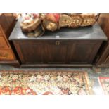 A 19th C. OAK COFFER WITH THE THREE PANELLED FRONT ABOVE A PLINTH FOOT. W 98 x D 49 x H