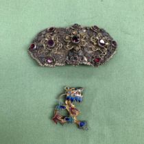 AN EASTERN SILVER GILT AND GEMSET BELT BUCKLE CONVERTED AS A BROOCH, TOGETHER WITH A SILVER GILT AND