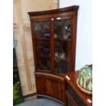 A 20th C. MAHOGANY CORNER CUPBOARD, THE INCURVED FRONT GLAZED ON THE UPPER HALF AND PANELLED ON