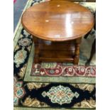 AN OAK COFFEE TABLE, THE CIRCULAR TOP ABOVE A SQUARE TIER JOINING THE BALUSTER LEGS AT THE FEET.