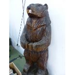 A LARGE CARVED WOODEN BEAR FIGURE.