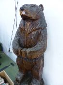 A LARGE CARVED WOODEN BEAR FIGURE.