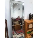 A 20th C. RECTANGULAR MIRROR WITH A PANELLING OF MIRRORS FORMING THE EDGE. 169 x 56cms.