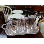 AN ELECTROPLATE FOUR PIECE TEA SET ON A TWO HANDLED TRAY