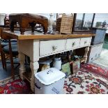 A PINE DRESSER WITH THREE CREAM PAINTED DRAWERS ABOVE A PLANK POT BOARD BETWEEN THE SQUARE SECTION