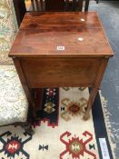 AN EDWARDIAN MAHOGANY WORK TABLE, THE HINGED LIDS LINE INLAID WITH OVALS AND MEETING CENTRALLY