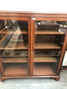 A 20th C. GLAZED MAHOGANY BOOKCASE ON BRACKET FEET. W 109 x D 32.5 x H 122cms.