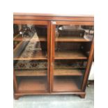 A 20th C. GLAZED MAHOGANY BOOKCASE ON BRACKET FEET. W 109 x D 32.5 x H 122cms.