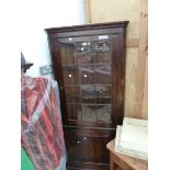 A 19th C. OAK CORNER CUPBOARD WITH A GLAZED DOOR TO THE UPPER HALF AND A PANELLED ONE BELOW. W 80