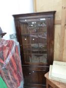 A 19th C. OAK CORNER CUPBOARD WITH A GLAZED DOOR TO THE UPPER HALF AND A PANELLED ONE BELOW. W 80