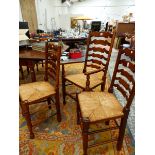 A SET OF EIGHT MAHOGANY LADDERBACK CHAIRS INCLUDING TWO WITH ARMS, EACH WITH RUSH SEATS