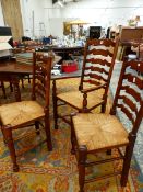 A SET OF EIGHT MAHOGANY LADDERBACK CHAIRS INCLUDING TWO WITH ARMS, EACH WITH RUSH SEATS