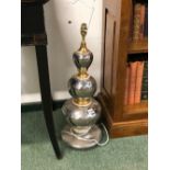 A LARGE SILVERED AND GILT DECORATED POTTERY TABLE LAMP.