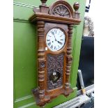 A VICTORIAN CARVED WALNUT DROP DIAL WALL CLOCK.