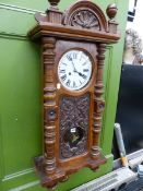 A VICTORIAN CARVED WALNUT DROP DIAL WALL CLOCK.