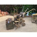 A PETROL BRIGGS AND STRATTAN ROTORVATOR. TOGETHER WITH TWO VINTAGE JERRY CANS