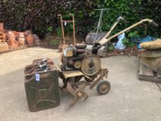 A PETROL BRIGGS AND STRATTAN ROTORVATOR. TOGETHER WITH TWO VINTAGE JERRY CANS