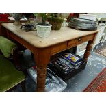 A PINE TABLE WITH A DRAWER TO ONE LONG SIDE ABOVE TURNED LEGS. W 121 x D 85 x H 73cms.