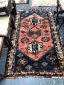 A PERSIAN TRIBAL RUG. 181 x 108cms