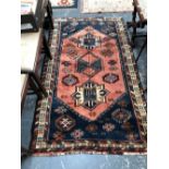 A PERSIAN TRIBAL RUG. 181 x 108cms