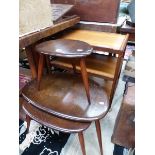 A NEST OF THREE ERCOL TABLES TOGETHER WITH A 1970S TEAK THREE TIER TROLLEY