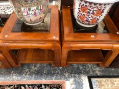 A PAIR OF MODERN CHINESE HARD WOOD TABLES, EACH WITH BEVELLED GLASS TOPS AND ON SCROLL LEGS JOINED