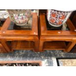 A PAIR OF MODERN CHINESE HARD WOOD TABLES, EACH WITH BEVELLED GLASS TOPS AND ON SCROLL LEGS JOINED