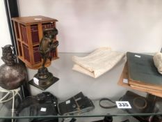 AN AIR NAVIGATORS LOG BOOK AND CLOTH MAP, A ROTARY BOOKCASE OF SHAKESPEARE PLAYS, A BRONZE FIGURE