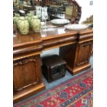 A VICTORIAN MAHOGANY MIRROR BACKED SIDEBOARD CRESTED WITH CARVED FRUIT, THE THREE OVOLO APRON