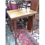 AN EDWARDIAN SATIN WOOD BANDED AND CONCH SHELL INLAID MAHOGANY SWIVEL TOP GAMES TABLE ON LINE INLAID