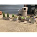 FIVE MATCHING COMPOSITE GARDEN PLANTERS WITH TWO OTHERS SIMILAR.